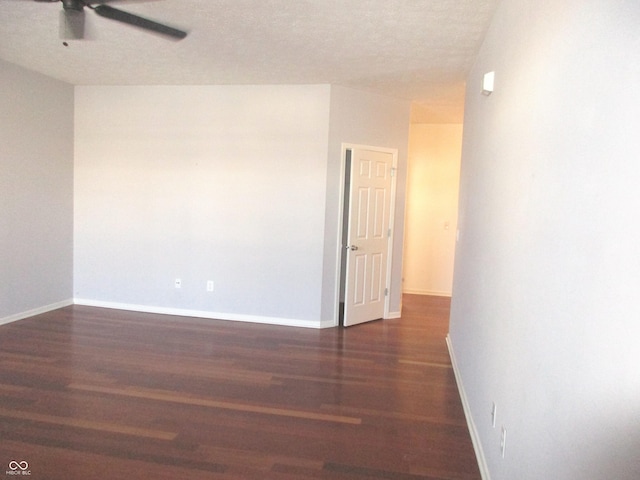 unfurnished room featuring ceiling fan and dark wood-type flooring