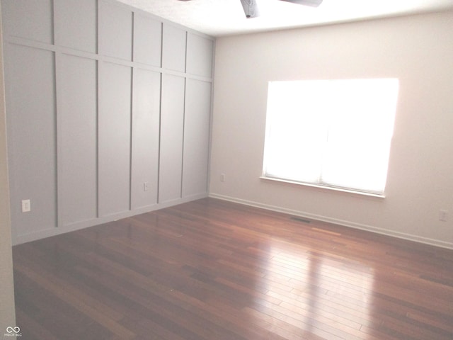 unfurnished bedroom featuring ceiling fan and dark hardwood / wood-style floors