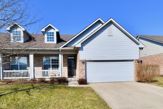 view of front of house featuring driveway, a porch, an attached garage, a front yard, and brick siding