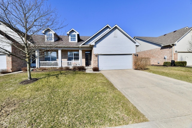 view of front of property with a front yard, a porch, concrete driveway, a garage, and brick siding