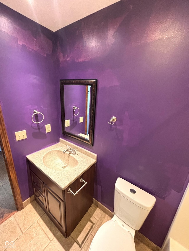 bathroom featuring tile patterned floors, toilet, and vanity