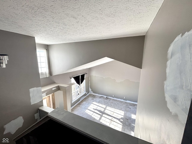 unfurnished living room with a textured ceiling