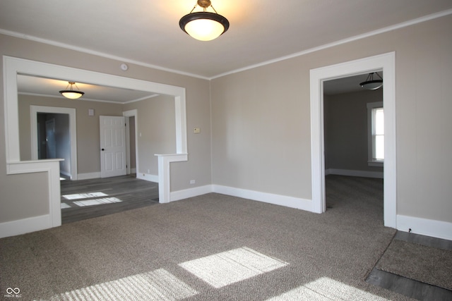 carpeted spare room featuring crown molding