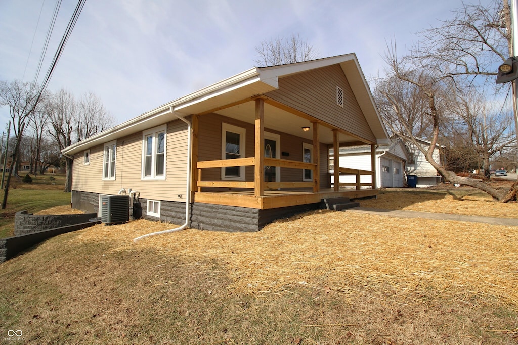 view of side of home featuring central AC unit and covered porch