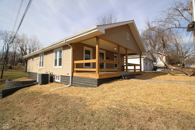 view of side of home featuring central AC unit and covered porch