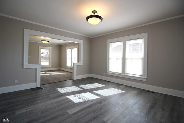 empty room featuring crown molding and dark hardwood / wood-style flooring