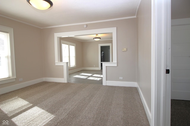 carpeted spare room with crown molding