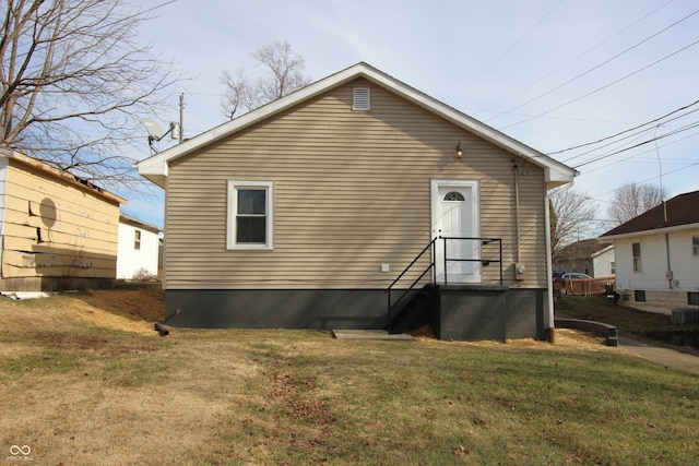 rear view of house with a yard