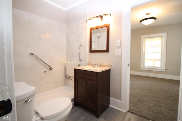 bathroom with vanity, a shower, and toilet