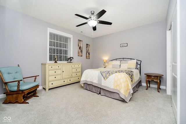 bedroom featuring ceiling fan and light carpet