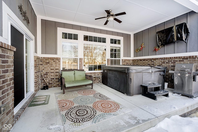 view of patio with grilling area, a hot tub, and ceiling fan