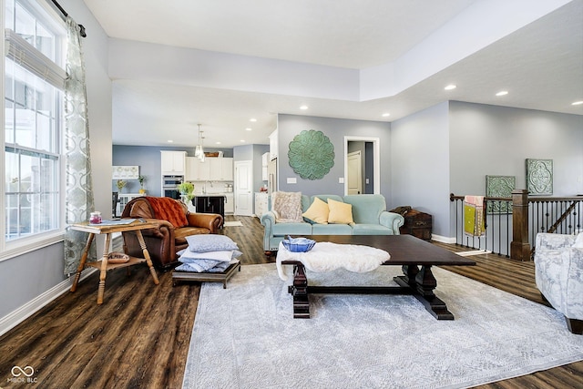 living room featuring a wealth of natural light and wood-type flooring