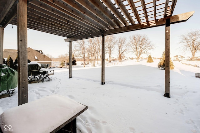 yard layered in snow with a pergola