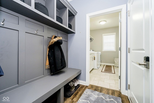 mudroom featuring separate washer and dryer and dark wood-type flooring