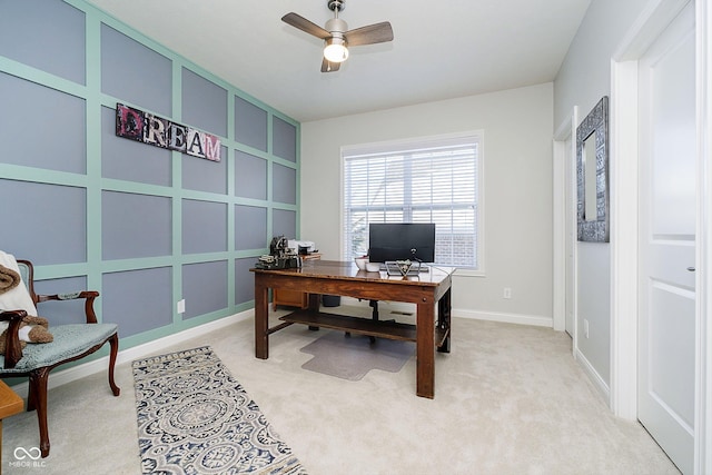 carpeted office space featuring ceiling fan