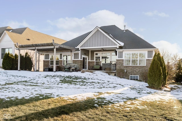 snow covered rear of property with a pergola and ceiling fan