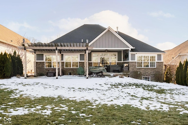 snow covered property featuring a hot tub