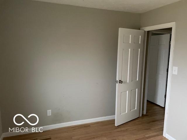 spare room featuring hardwood / wood-style flooring