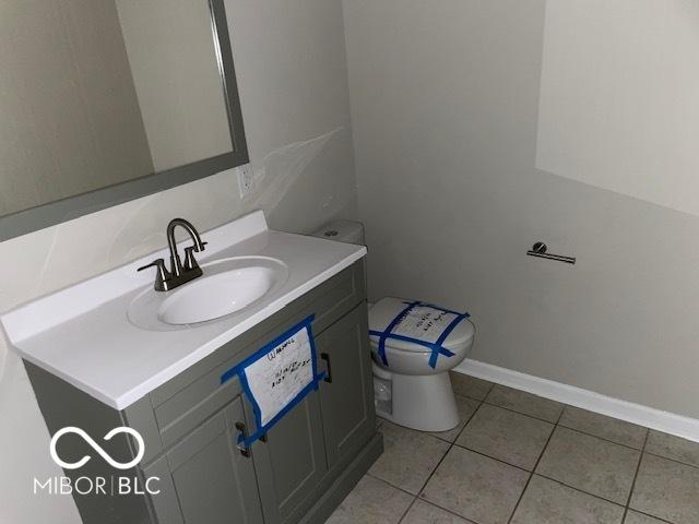 bathroom with tile patterned floors, vanity, and toilet