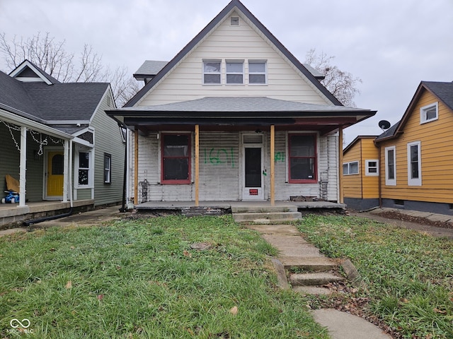 bungalow-style house with a front yard and covered porch