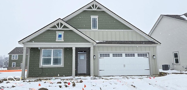 view of front of home with a garage and cooling unit