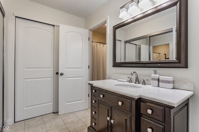 bathroom with tile patterned floors and vanity