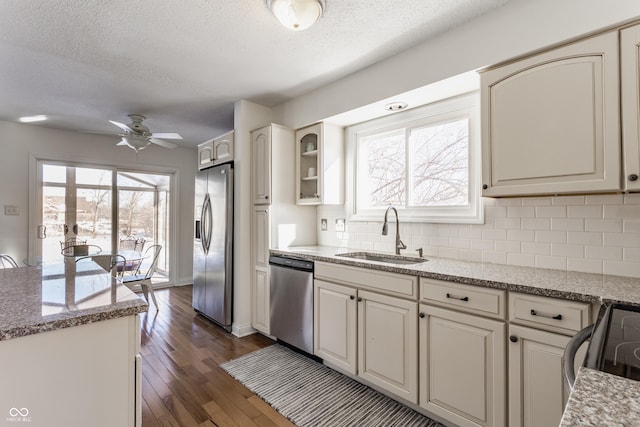 kitchen featuring ceiling fan, sink, a textured ceiling, and stainless steel appliances