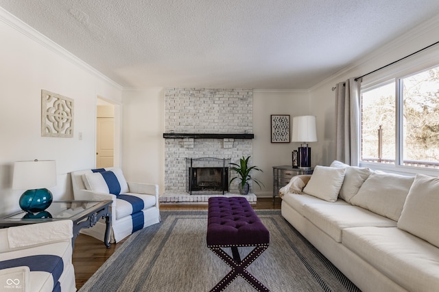 living room featuring a textured ceiling, a brick fireplace, dark hardwood / wood-style flooring, and crown molding