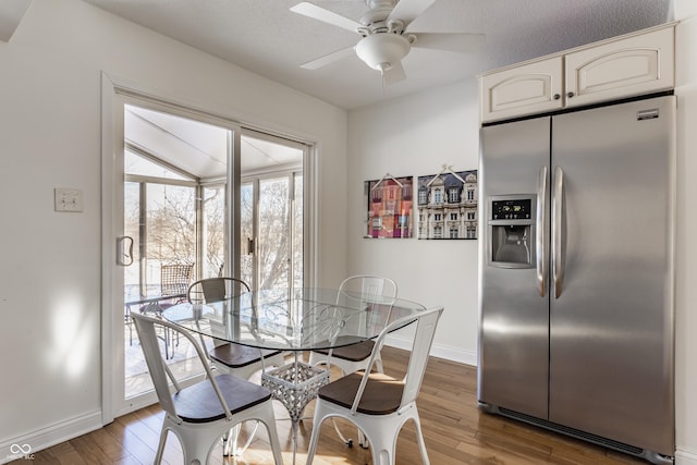 dining room with ceiling fan, wood-type flooring, and a textured ceiling