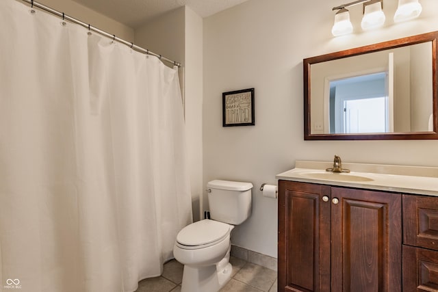 bathroom with toilet, tile patterned flooring, and vanity