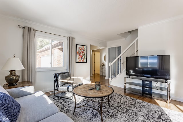 living room with dark hardwood / wood-style flooring and ornamental molding