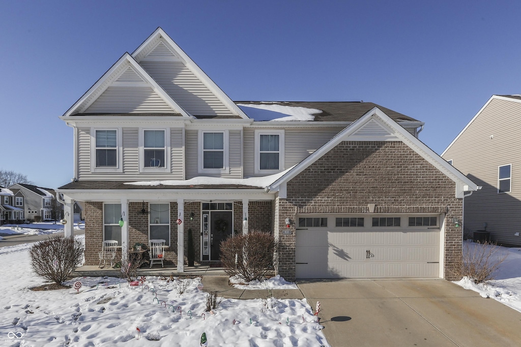 front facade featuring a porch and a garage