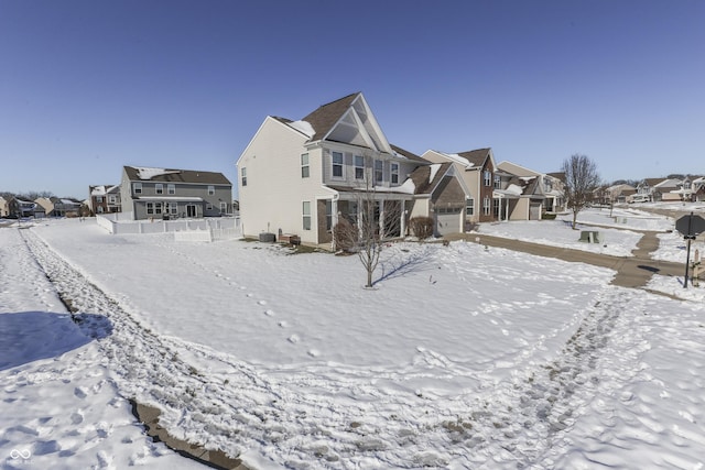 view of snow covered back of property