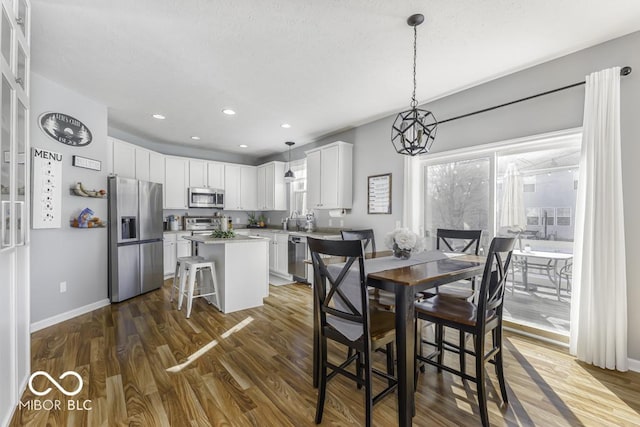 dining area featuring dark hardwood / wood-style floors and sink