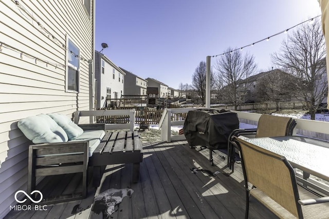 snow covered deck with a grill