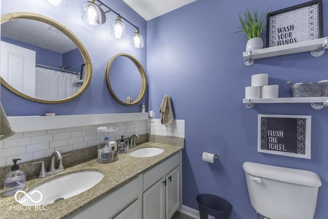 bathroom with vanity, decorative backsplash, and toilet