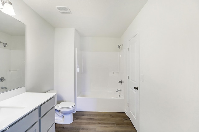 full bathroom featuring bathtub / shower combination, wood-type flooring, toilet, and vanity