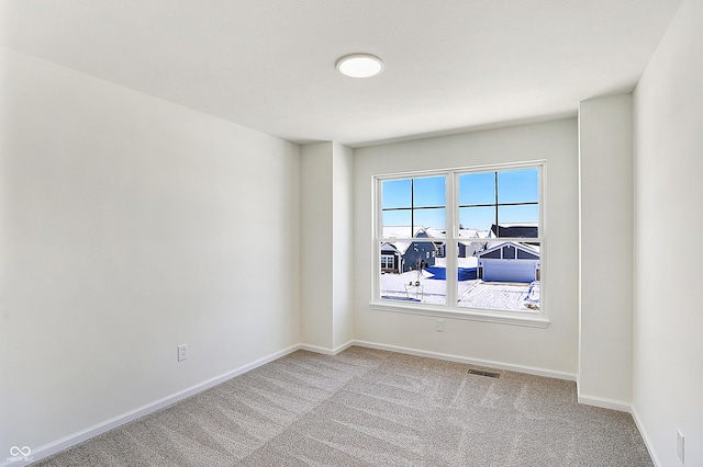 unfurnished room with light colored carpet