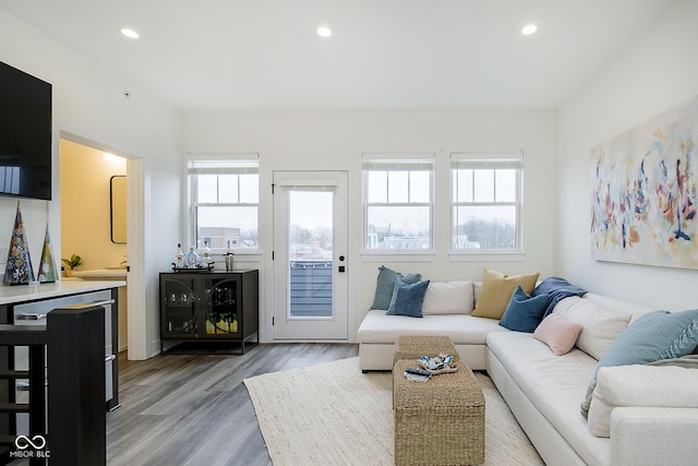 living room with beverage cooler and light hardwood / wood-style floors