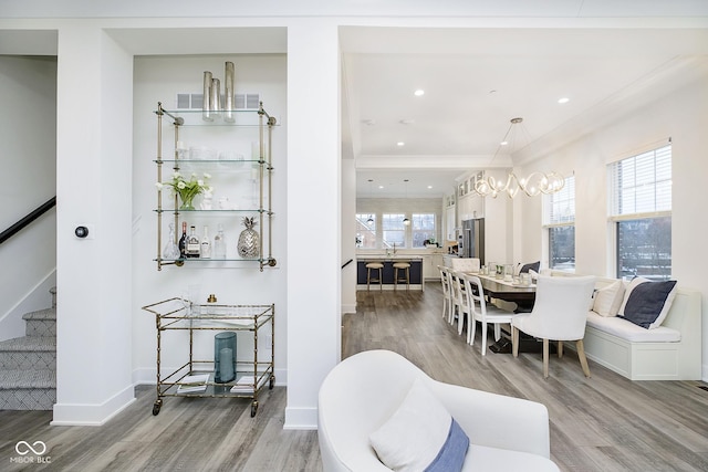 dining area with crown molding, hardwood / wood-style floors, and a wealth of natural light