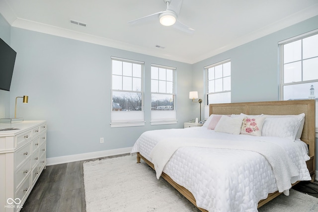 bedroom featuring dark hardwood / wood-style flooring, ceiling fan, and ornamental molding