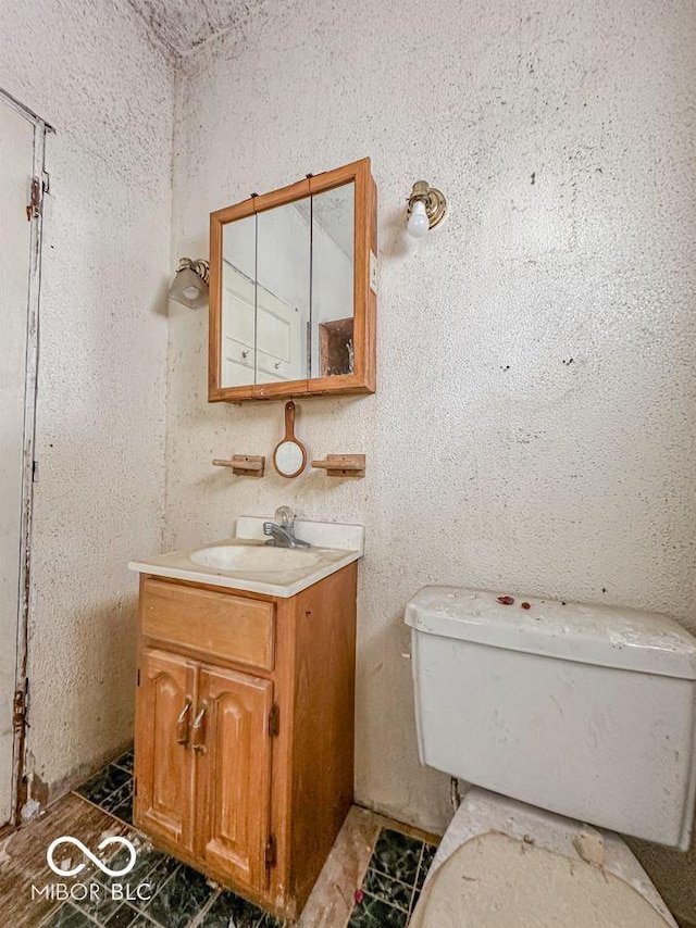 bathroom featuring vanity and toilet