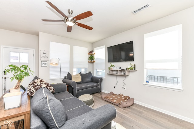 living room with ceiling fan and light hardwood / wood-style floors