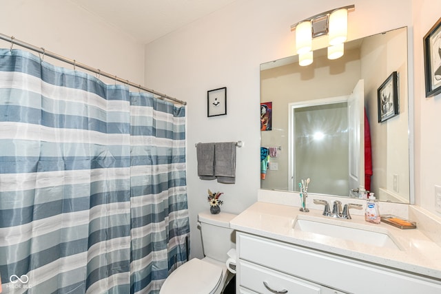 bathroom featuring toilet, a shower with curtain, and vanity