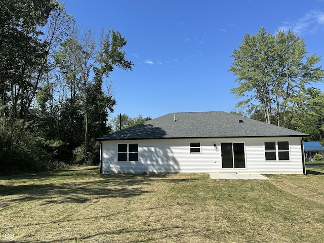 rear view of house with a yard