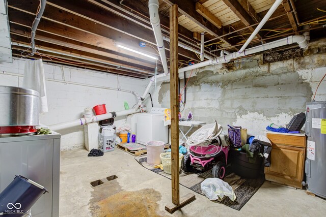 basement with water heater and independent washer and dryer