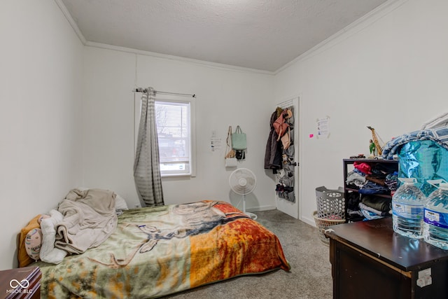 bedroom featuring ornamental molding, carpet floors, and a textured ceiling