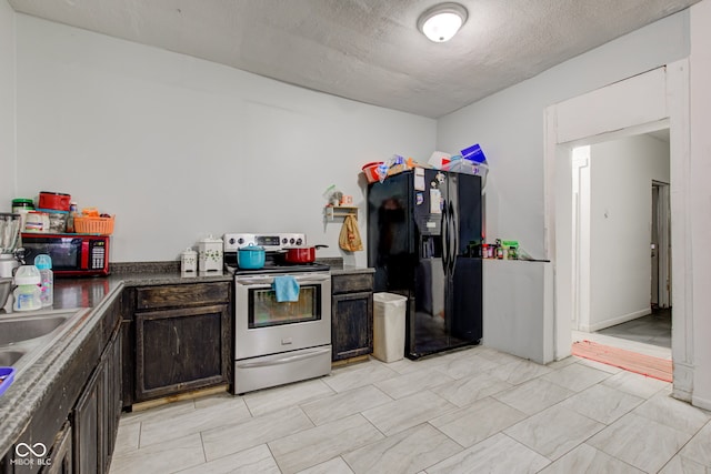 kitchen featuring black fridge, dark brown cabinets, a textured ceiling, and stainless steel range with electric stovetop