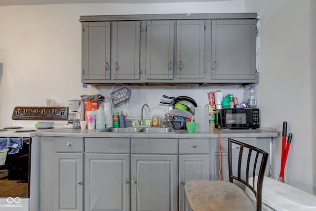 kitchen with sink, white electric range, and gray cabinetry