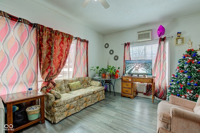 sitting room featuring a textured ceiling, ceiling fan, and light hardwood / wood-style flooring